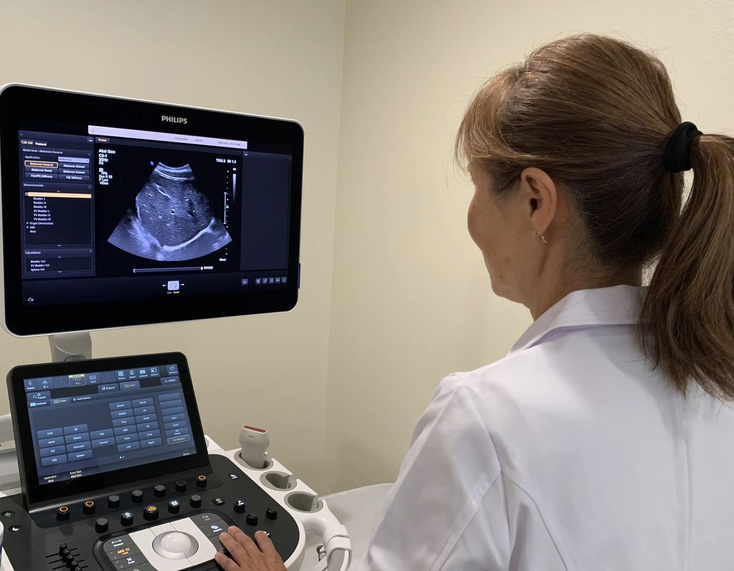 Dr. Kate Kyungmi Moon performing an ultrasound examination on a Philips system